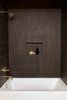 Modern home with Bath Room, Alcove Tub, and Ceramic Tile Wall. Accessible from both the Green Room and the Pool House, the dark-toned guest bath features tiled walls by Heath Ceramics, a tub and sink by Duravit, and fixtures by California Faucets. Photo 17 of Federal Bungalow