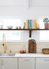 Modern home with Kitchen and Medium Hardwood Floor. As in the Fairview, the Federal incorporates a few “IKEA hacks” such as the Ikea kitchen cabinets combined with modern front and cover panels by Reform. The faucet is by California Faucets. Photo 11 of Federal Bungalow