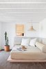 Modern home with Living Room, Pendant Lighting, Sofa, and Ceramic Tile Floor. The Pool House is also outfitted with a Moroccan-style day bed with a Wright mattress. Photo 16 of Federal Bungalow