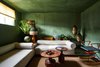 Modern home with Living Room, Sofa, Coffee Tables, and Medium Hardwood Floor. “Admittedly, I’m really excited about the green room,” says McKinley. “This living room is bold and fresh in a way that isn’t overpowering. I feel like its aesthetic further nurtures the space’s contemporary charm. We were proud to work with Domingue on the finish, which is all lime-based – the depth and texture they are able to capture is truly unparalleled!” Photo 14 of Federal Bungalow