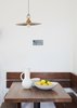 Modern home with Dining Room, Medium Hardwood Floor, Table, and Ceiling Lighting. A kitchen nook with Heath Ceramics bowls occupies a corner of the living area. Photo 13 of Federal Bungalow
