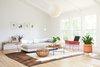 Modern home with Living Room, Sofa, Chair, Pendant Lighting, Medium Hardwood Floor, and Coffee Tables. “It feels very much like a home, where we mixed products from our design partners together very organically, whether they be books, textiles, ceramics or furniture, so there is a sense of inspiration and discovery," says McKinley. Photo of Federal Bungalow