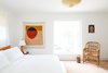 Modern home with Bedroom, Pendant Lighting, Medium Hardwood Floor, Wall Lighting, Chair, and Bed. McKinley purchased the handwoven Marni chair from the 2019 Salone del Mobile in Milan. Photo 10 of Federal Bungalow