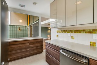 Before the renovation, the original kitchen had felt dark and dated with wooden cabinetry and quarry tile flooring.