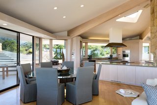 Exposed wood ceiling trusses help delineate the different spaces in the great room.