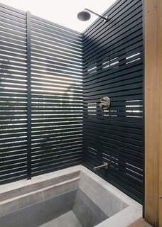 The ground floor of the Front House holds an onsen-inspired bathroom with an outdoor tub/shower that faces the courtyard and “encourages relaxation and the spirit of communal bathing.”