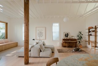 The existing wood structure and ceiling of the former saloon were completely refinished, and the exposed rafters were painted white for a brighter and more spacious feel. The old windows, floors, and finishes were replaced to create consistency with the new house.