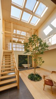 Since the house is edged in by homes on the east, west, and south sides, the architect punctuated the gabled roof with large skylights to bring daylight into the home.