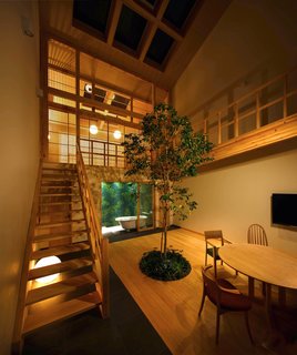 The House in Kyoto illuminated with select lighting at night.