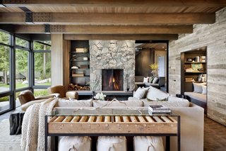 "The steel-and-wood beam details in the living room, dining room, and kitchen are a nod to the fact that the big open span facing the water is achieved with a large steel beam up in the ceiling from which all those large wood beams are suspended," notes the firm. The natural materials palette in the interior includes Pioneer Millworks 'Prairie' reclaimed wood siding for the walls, stained clear vertical grain cedar ceilings (main level), and solid end grain hemlock flooring by Oregon Lumber.