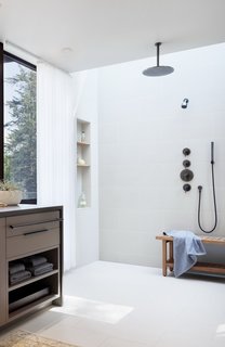 The master bath features Everstone Parc porcelain tiles and Crossville Ready-to-Wear Porcelain Stone for the accent wall.