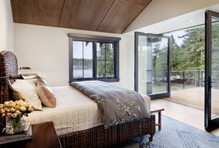 Large operable walls of glass open the master bedroom up to an outdoor deck. The client's bed is equipped with casters to allow it to roll in and out onto the deck.