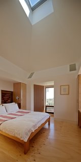 Housed inside the kiln is a bedroom with an operable skylight that serves as a thermal chimney for passive cooling.