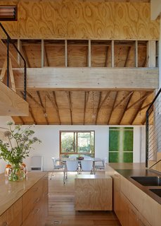 Simpson retained the original roof trusses and left them exposed as a reminder of the building's industrial heritage. The etched panels recycled from Anderson's former art installation line the ceiling above the trusses.