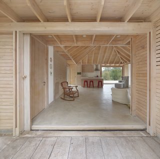 The extended roof eave wraps around the building for shelter and protection from the sun.