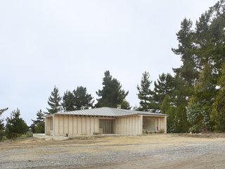 Located two hours from the clients' home in Santiago, the House in El Peumo is set on a sandy plateau surrounded by pines and cypresses.