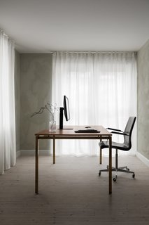 A peek at the office space with a Frama-designed leather-and-brass desk. The ground floor also houses the kitchen, dining area, and living room.