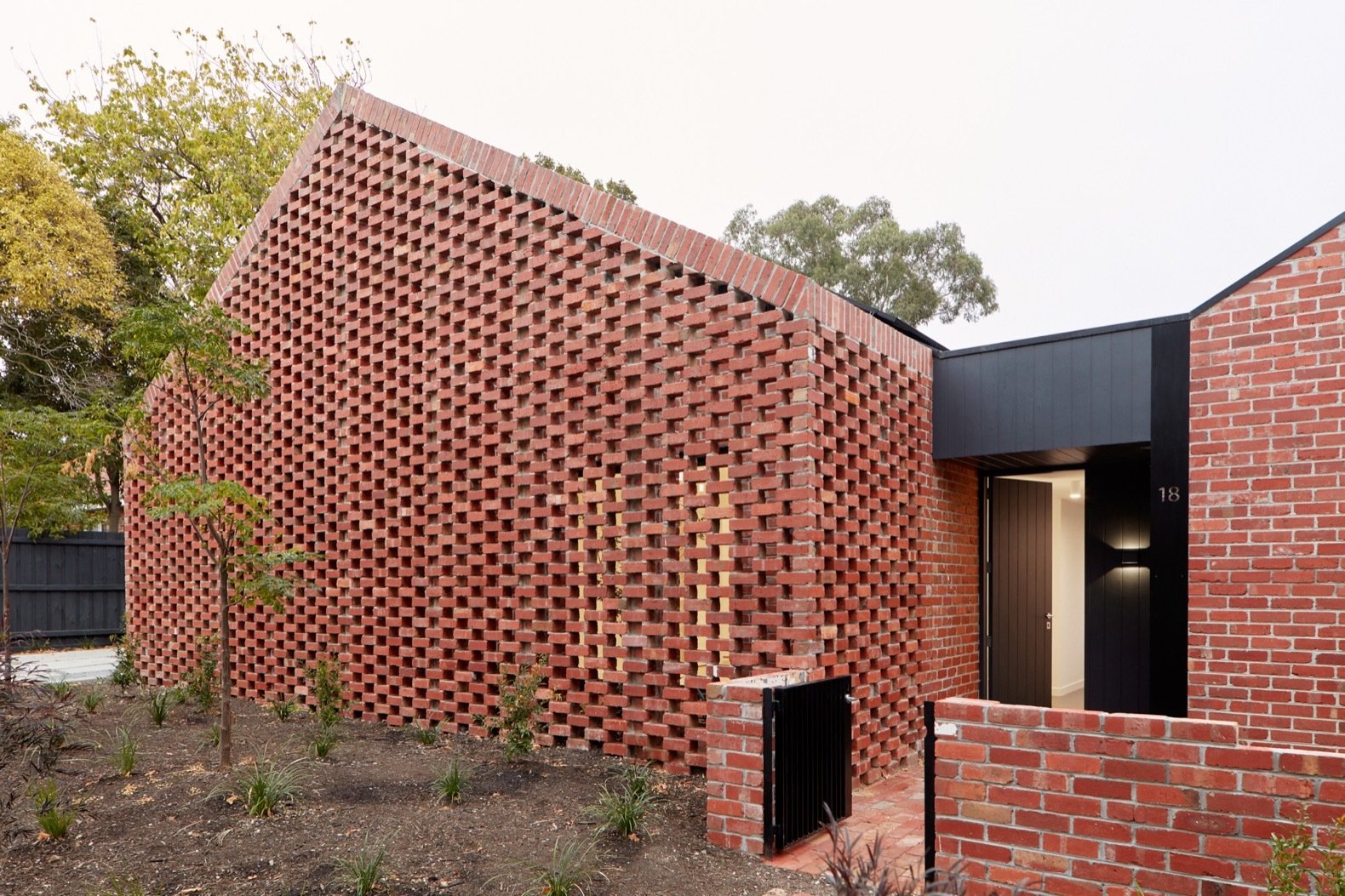Photo 2 of 10 in Recycled Red Brick Wraps Two Affordable Rental Homes