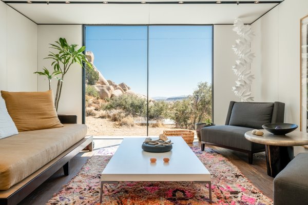 The light-filled living room on the east side of the house is furnished with an Opium day bed and Christian Liagre chairs for Holly Hunt.