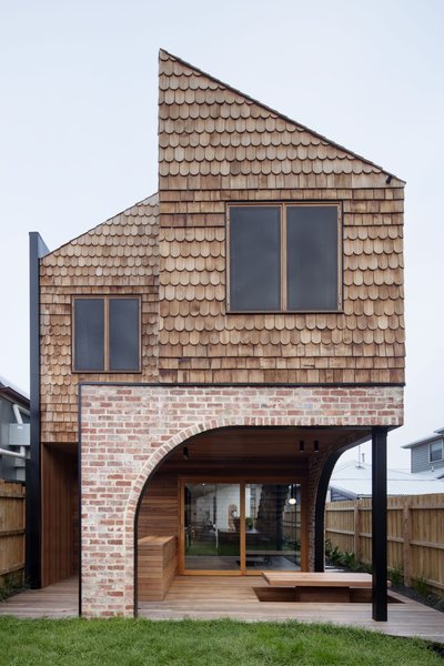 A view of the rear of the home. Recycled materials, such as salvaged red bricks and steel window details, were repurposed from other building sites.