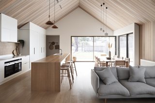 The raked red cedar ceiling is one of the couple’s favorite aspects of the home. They are particularly enamored with “the small shadow lines we created in the junction between the raked ceiling and the plaster bulk heads…it’s such a tiny detail that tightens everything up.”