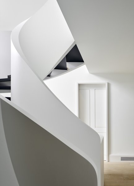 The sculptural curving stair captures the changing light during different times of day.