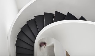 The central staircase connects all three floors of the 7,000-square-foot Toronto townhouse.