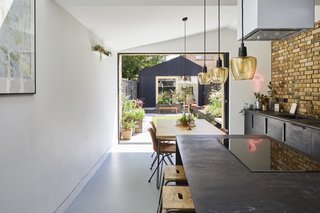 To create a strong connection between the home and the spacious rear garden, the couple emphasized spaces at the rear of the home and added full-height sliding pocket doors for unobstructed views of the garden.