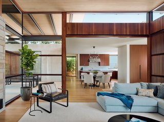 The homeowners took advantage of virtual reality technology for selecting and placing their furniture, including the pictured Reid section from DWR and Black Marble Saarinen dining table with Cora custom side chairs from Room and Board.