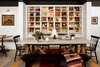 Modern home with Living Room, Table, Concrete Floor, Chair, and Wall Lighting. A communal work table and seating gives guests a place to exchange stories at the end of the day. Note the small library behind with guide and adventure books. Photo 9 of Cache House