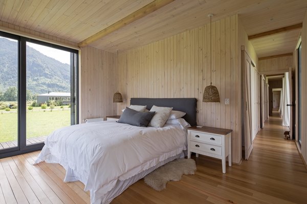 The main bedroom bookends the west side of the home and opens up to the outdoors via glass sliders on two sides.