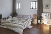 Modern home with Ceiling Lighting, Medium Hardwood Floor, and Chair. The bedroom. Rustic oak hardwood flooring, create a warm and homey touch, however, contemporary and neat. Photo 12 of C Studio Apartment