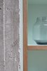 Modern home with Kitchen, Colorful Cabinet, and Wood Cabinet. An exposed concrete column frames the birch plywood and mint green formica kitchen. Photo of C Studio Apartment