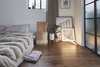 Modern home with Chair and Medium Hardwood Floor. A velvet chair designed by the architects, along with selected art works and a light object designed by lighting designer, Naama Hofman. Photo 13 of C Studio Apartment