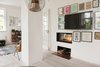 Modern home with Living Room, Pendant Lighting, Light Hardwood Floor, and Wood Burning Fireplace. Framed artwork and a sleek rectangular built-in fireplace leave the television almost unnoticed. Photo 13 of Colorful & Eclectic Danish Home