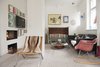 Modern home with Living Room, Chair, Pendant Lighting, Sofa, Light Hardwood Floor, Wood Burning Fireplace, and Coffee Tables. Living area features a collection of chairs, rockers, sofas, and benches. Photo 10 of Colorful & Eclectic Danish Home