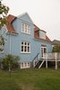 Modern home with Exterior, House Building Type, Shingles Roof Material, and Brick Siding Material. This lovely blue Copenhagen home is a short walk from the sea. Photo of Colorful & Eclectic Danish Home