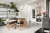 Modern home with Dining Room, Table, Chair, Lamps, Shelves, Storage, Pendant Lighting, Medium Hardwood Floor, and Wood Burning Fireplace. Scandinavian dining room featuring winding white staircase and wood burning stove Photo 3 of Minimalist Nordic Flat