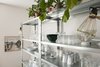 Modern home with Dining Room, Storage, Shelves, and Accent Lighting. Open metal shelving filled with glassware and ceramic cups and dishes Photo 4 of Minimalist Nordic Flat