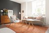 Modern home with Living Room, Chair, Sofa, Coffee Tables, Lamps, Table Lighting, Floor Lighting, and Medium Hardwood Floor. A vibrant orange floor rug offsets a grey toned palette in this contemporary living room Photo 7 of Minimalist Nordic Flat
