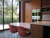 Modern home with Kitchen, Engineered Quartz Counter, Wood Cabinet, Concrete Floor, Wall Oven, and Microwave. View from Kitchen to Greenway Photo 6 of Before House