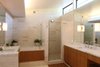 Modern home with Bath Room, Stone Counter, Travertine Floor, Undermount Sink, Undermount Tub, Soaking Tub, Corner Shower, Wall Lighting, Accent Lighting, and Stone Tile Wall. Master Bathroom Photo 8 of Before House
