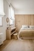 Modern home with Bedroom, Bed, Wall Lighting, and Light Hardwood Floor. Oak lines the walls and floor of the master bedroom Photo 7 of The Oak Residence by Quiet Studios