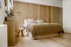 Modern home with Bedroom, Bed, Light Hardwood Floor, and Wall Lighting. The master bedroom Photo 8 of The Oak Residence by Quiet Studios