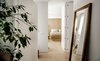 Modern home with Light Hardwood Floor. A mirror stands at the entrance of the apartment Photo 17 of The Oak Residence by Quiet Studios