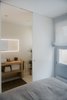 Modern home with Wood Counter and Wall Lighting. The ensuite guest bathroom Photo 15 of The Oak Residence by Quiet Studios