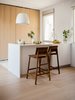 Modern home with Kitchen, Wood Cabinet, Light Hardwood Floor, and Ceiling Lighting. Teak stools sit at the breakfast bar Photo 2 of The Oak Residence by Quiet Studios