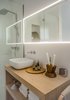 Modern home with Wood Counter and Wall Lighting. Guest bathroom with oak vanity Photo 16 of The Oak Residence by Quiet Studios