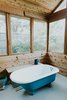 Salvaged 1910s clawfoot tub in screened porch Photo 13 of Oak Cliff Home modern home