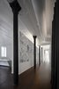 Modern home with Hallway and Dark Hardwood Floor. Along the main hall we installed graphic wallpaper, introducing a new field of texture and tone and transforming the experience of moving between the front and back of the apartment. Photo 2 of Broome Street Loft